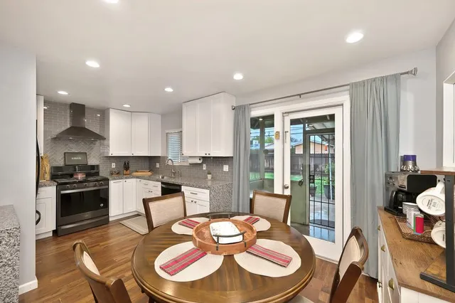 a kitchen with a dining table and chairs