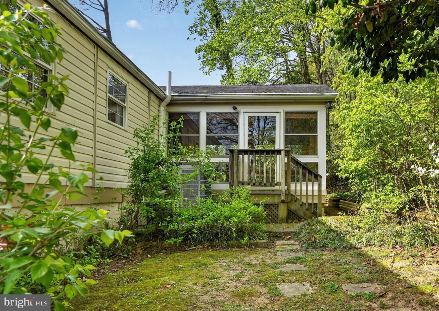 5914 Freds Oak Road Burke, VA 22015 - Photo 14 of 30 a front view of a house with a yard and potted plants