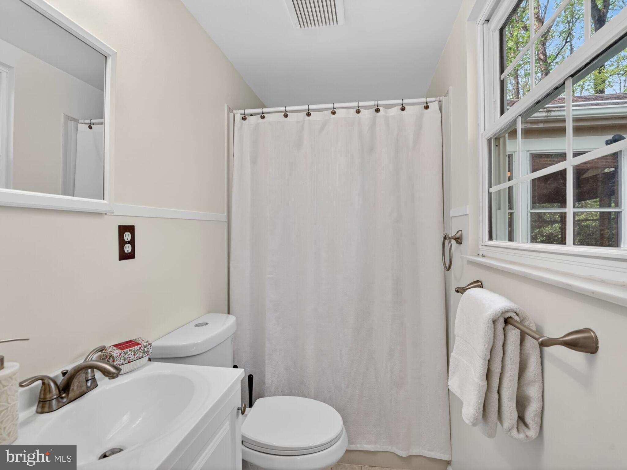 5914 Freds Oak Road Burke, VA 22015 - Photo 17 of 30 a white toilet sitting next to a bathroom sink