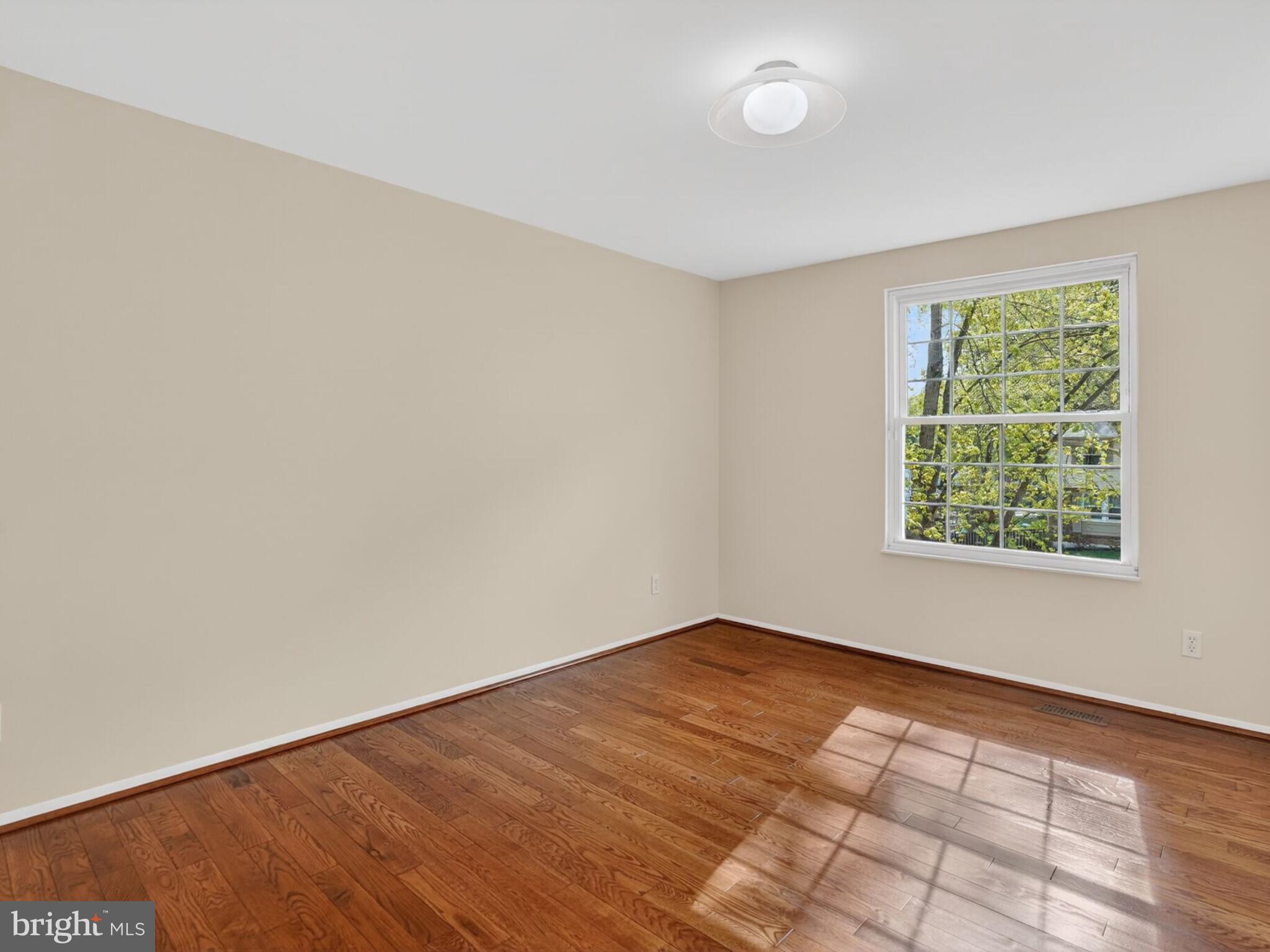 5914 Freds Oak Road Burke, VA 22015 - Photo 18 of 30 an empty room with wooden floor and windows