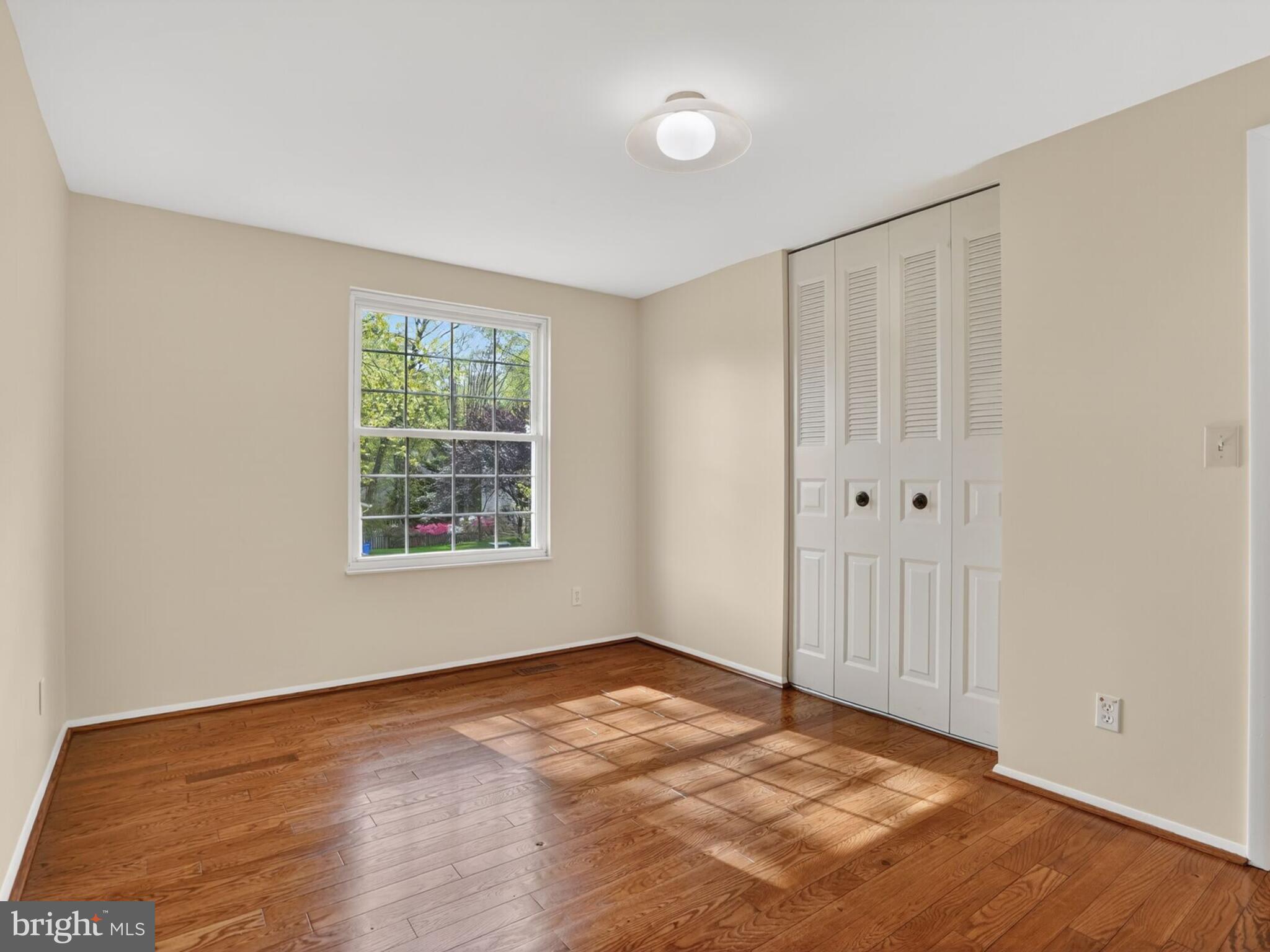 5914 Freds Oak Road Burke, VA 22015 - Photo 19 of 30 a view of an empty room with wooden floor and a window