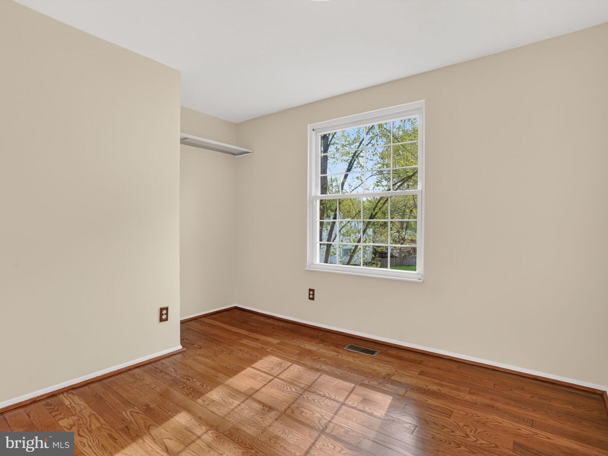 5914 Freds Oak Road Burke, VA 22015 - Photo 20 of 30 a view of an empty room with wooden floor and a window