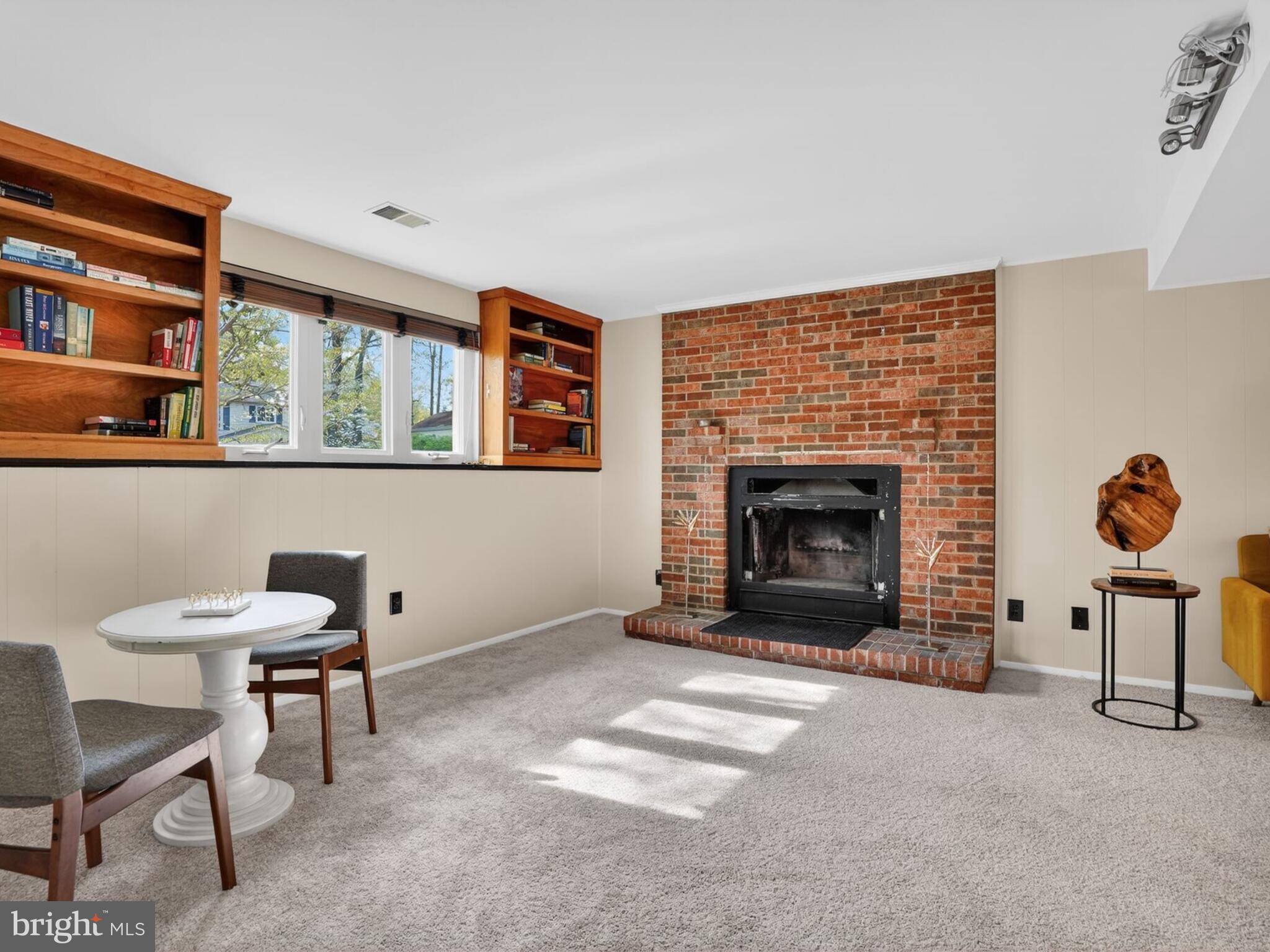 5914 Freds Oak Road Burke, VA 22015 - Photo 22 of 30 a living room with furniture and a fireplace