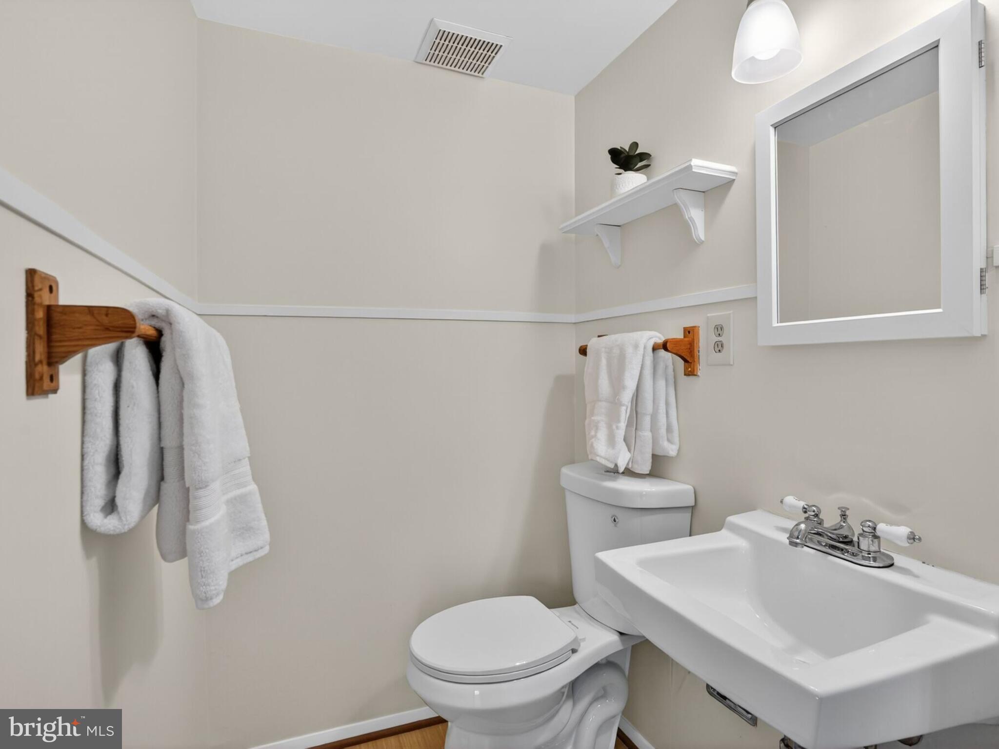 5914 Freds Oak Road Burke, VA 22015 - Photo 27 of 30 a bathroom with a sink vanity mirror and toilet