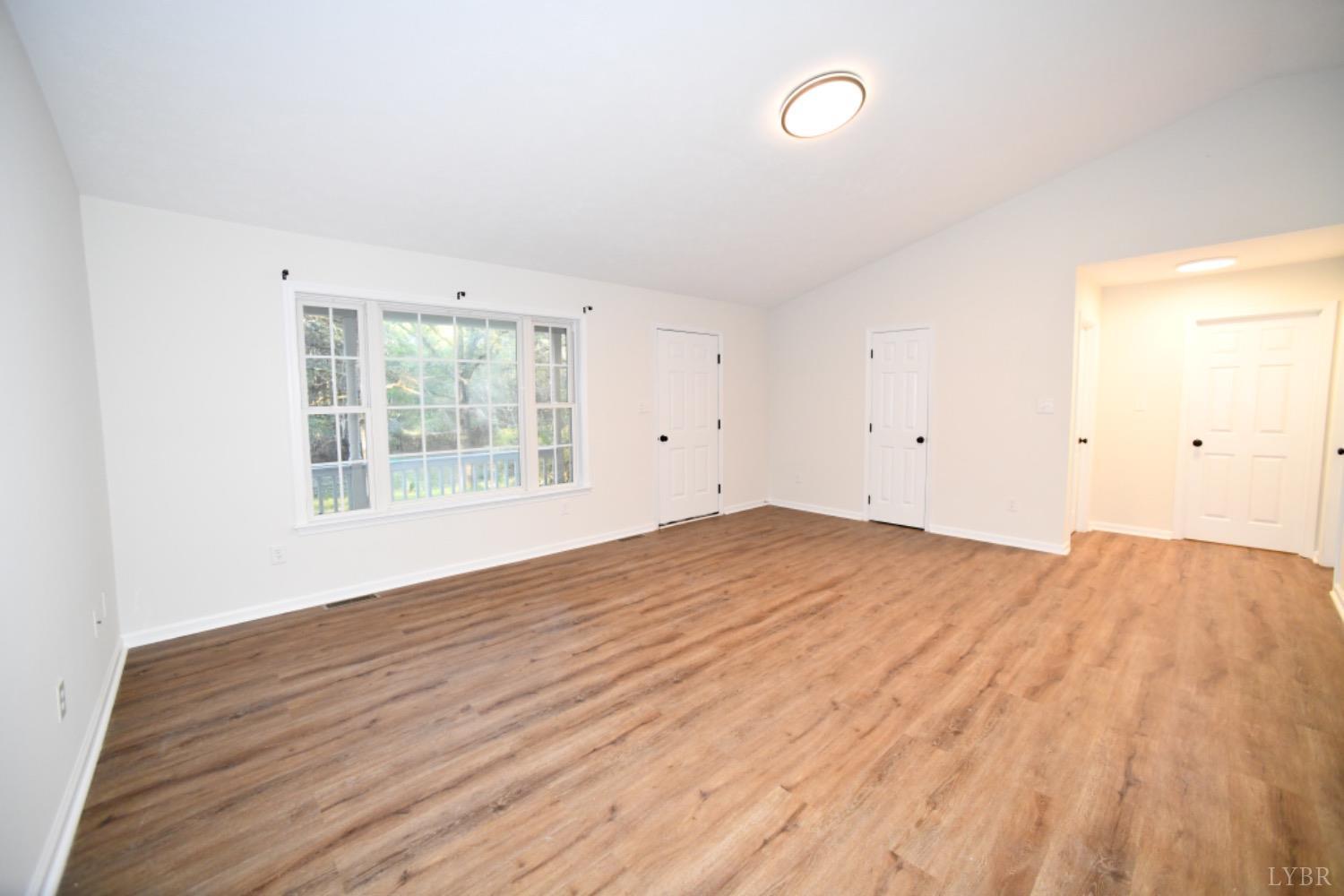 299 Sunset Ridge Drive Farmville, VA 23901 - Photo 20 of 38 an empty room with wooden floor and windows
