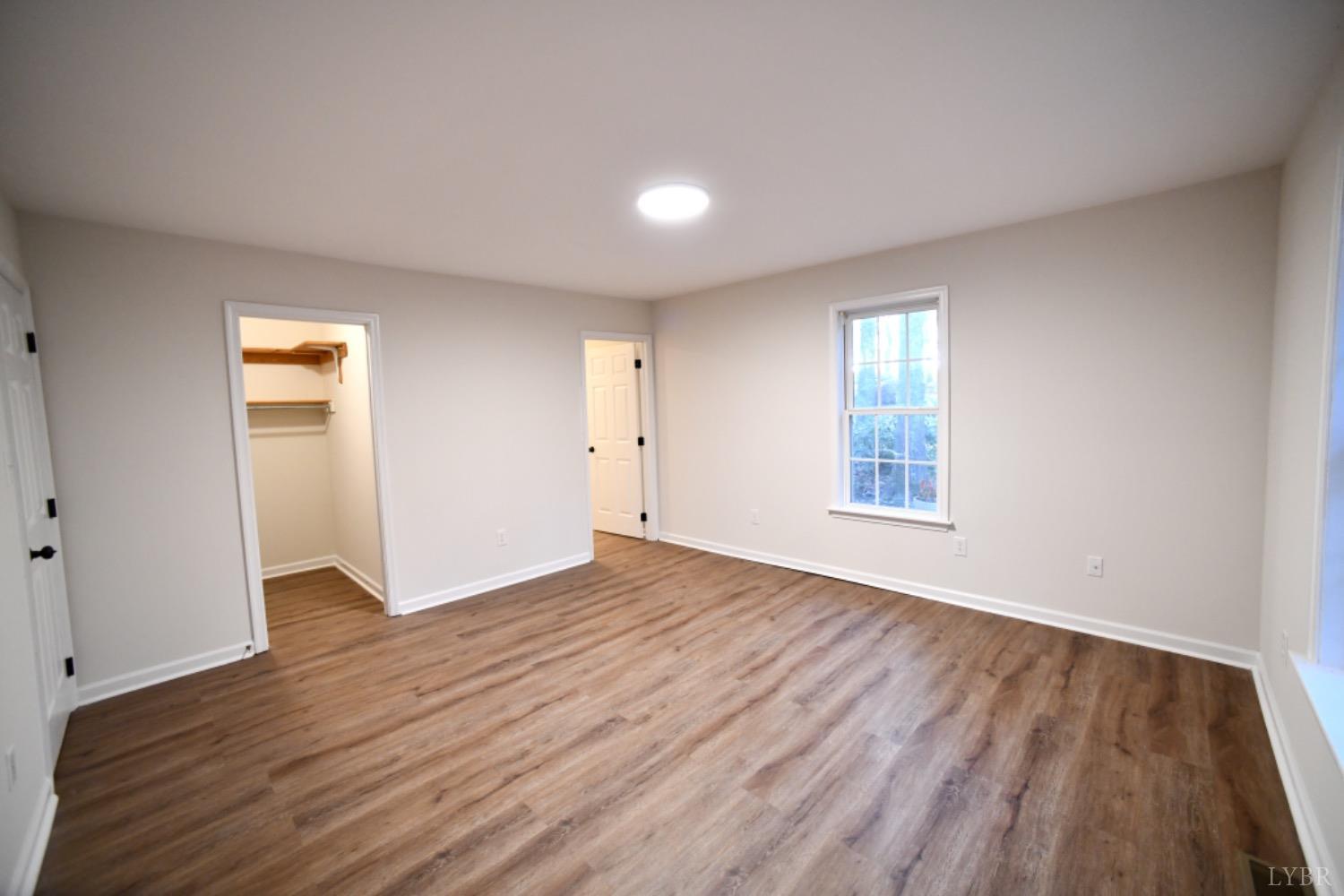299 Sunset Ridge Drive Farmville, VA 23901 - Photo 28 of 38 an empty room with wooden floor and windows