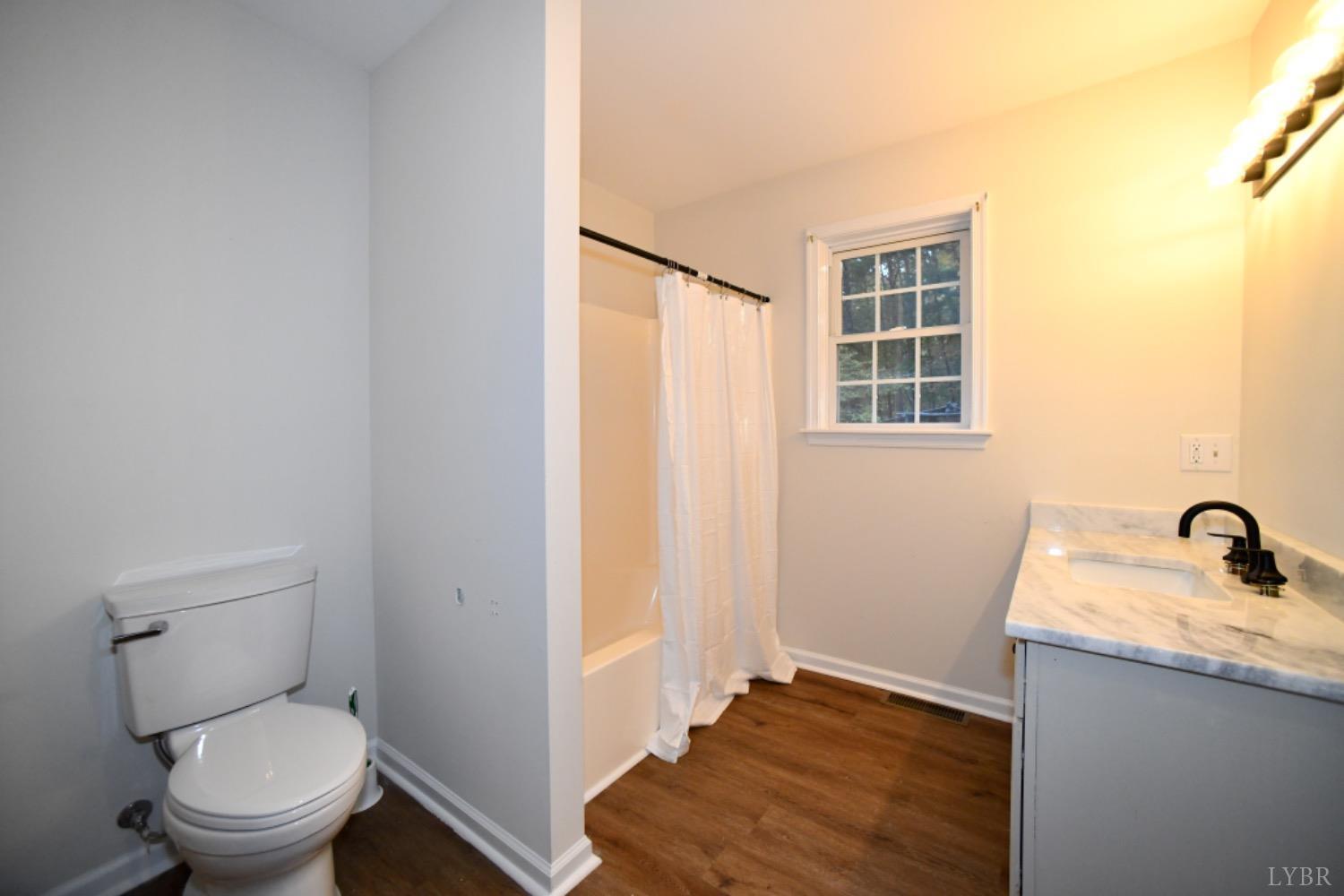299 Sunset Ridge Drive Farmville, VA 23901 - Photo 31 of 38 a bathroom with a granite countertop sink toilet and shower