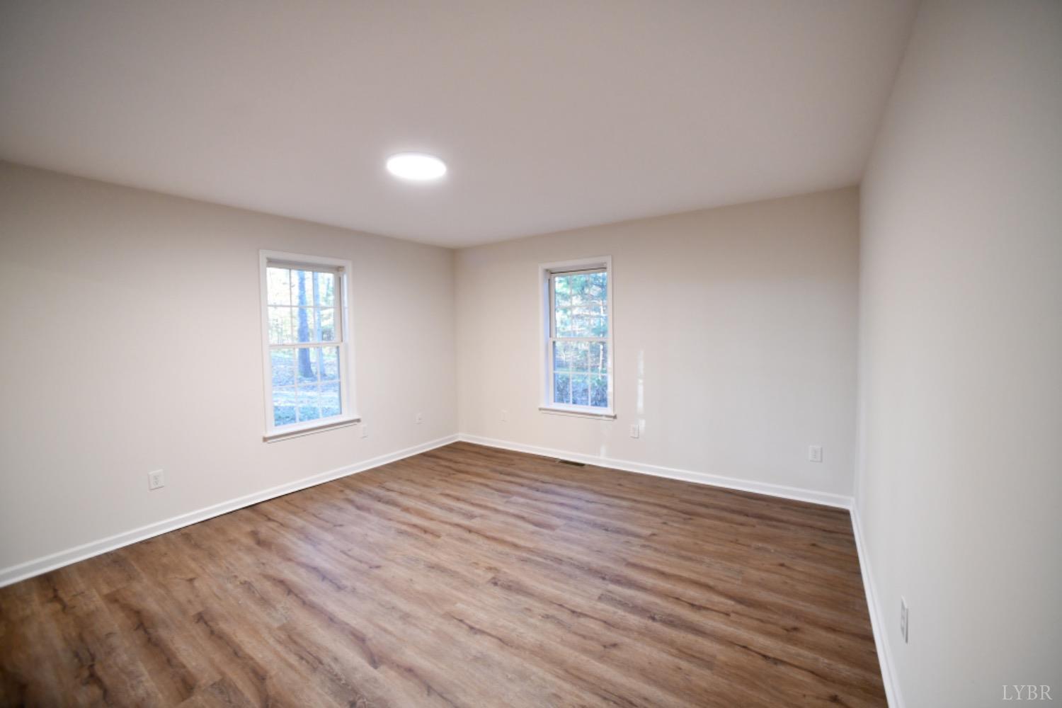 299 Sunset Ridge Drive Farmville, VA 23901 - Photo 33 of 38 an empty room with wooden floor and windows