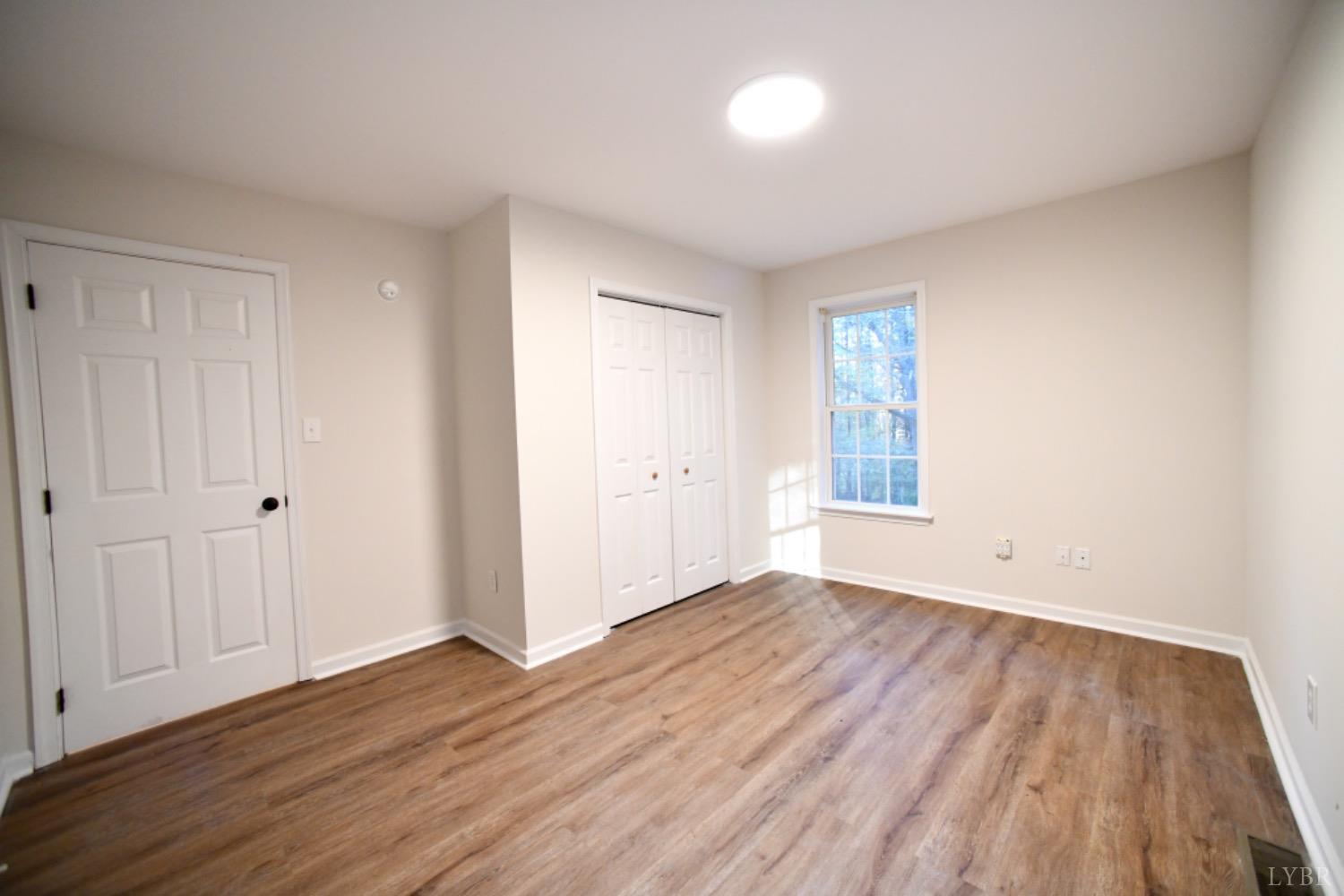 299 Sunset Ridge Drive Farmville, VA 23901 - Photo 37 of 38 a view of an empty room with wooden floor and a window