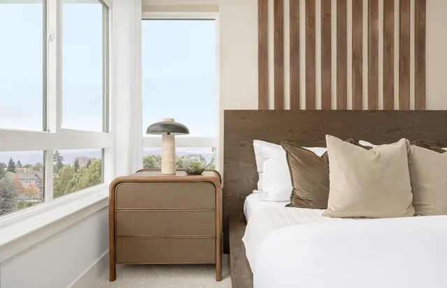 a bed sitting in a bedroom next to a window