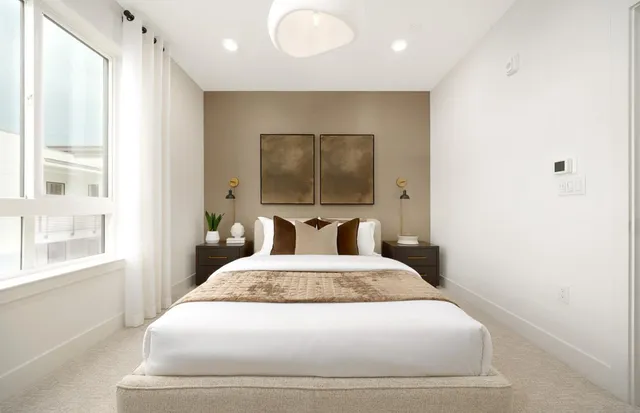 a large white bed in a white room