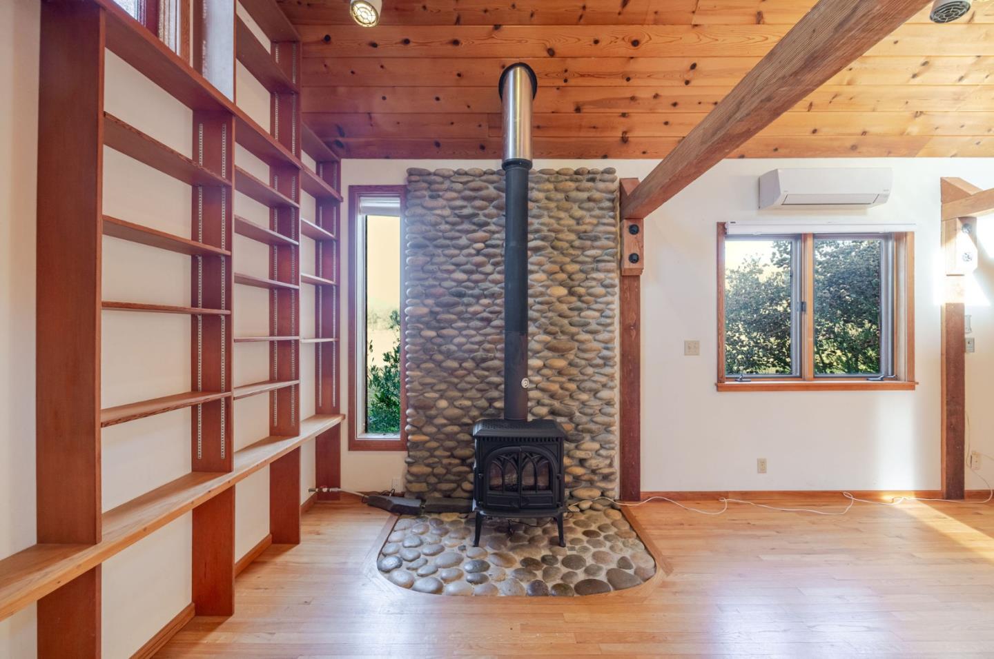 1009 Miramontes Street Half Moon Bay, CA 94019 - Photo 28 of 69 a room with fireplace and wooden floor