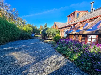 an aerial view of a house with a lake view