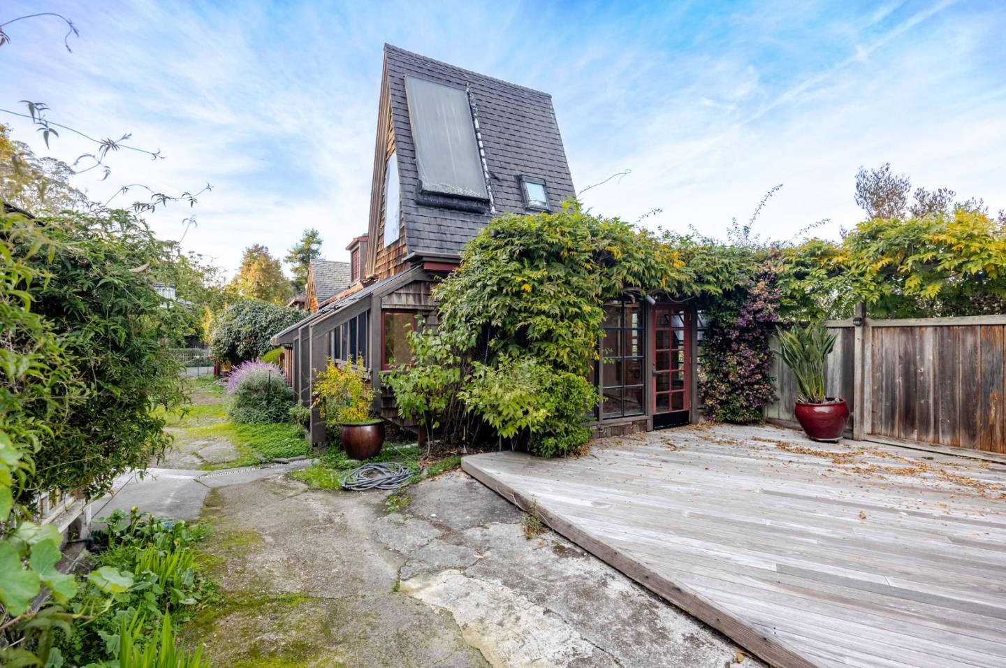 1009 Miramontes Street Half Moon Bay, CA 94019 - Photo 39 of 69 a view of a house with potted plants and a large tree