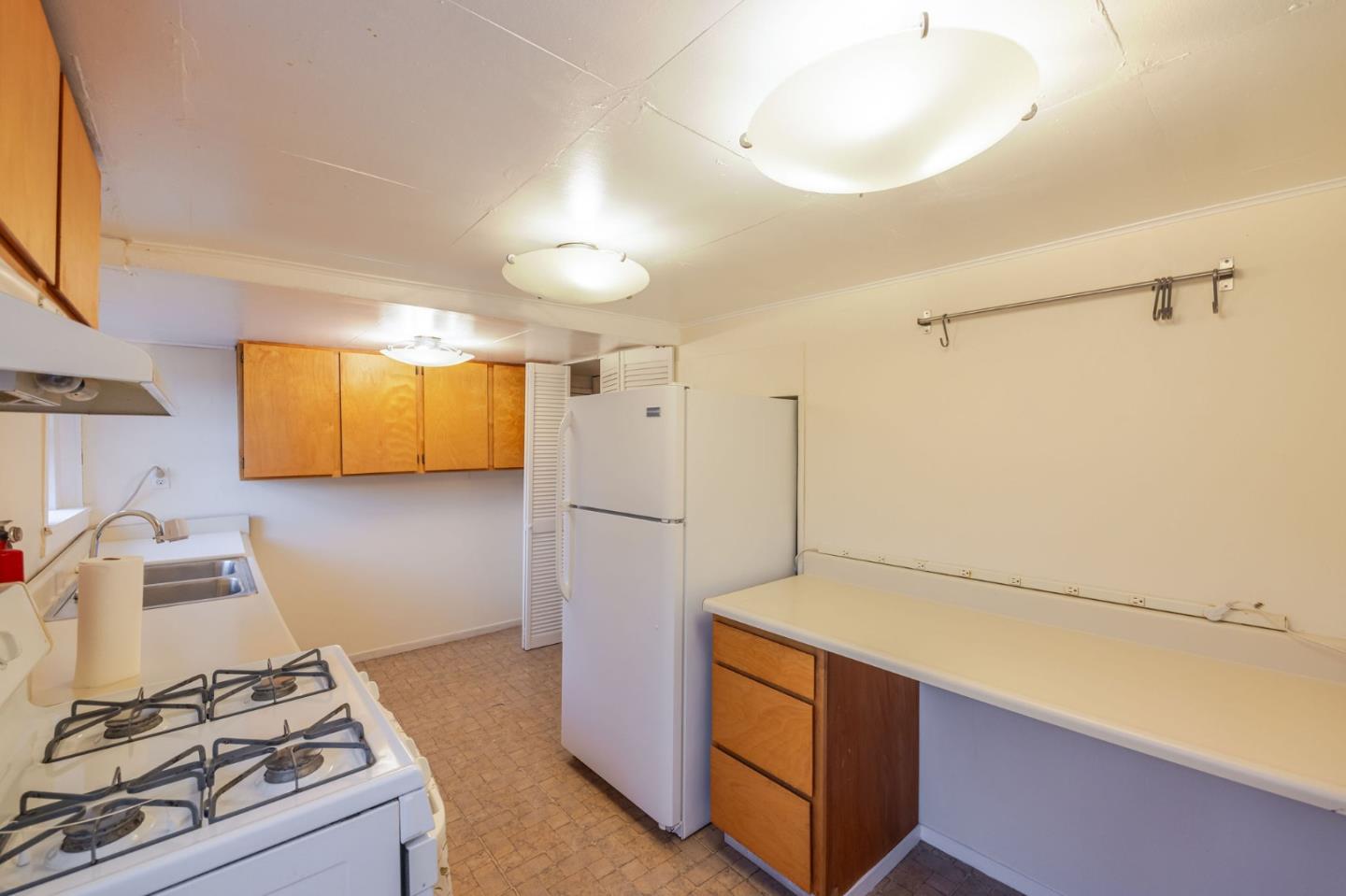 1009 Miramontes Street Half Moon Bay, CA 94019 - Photo 46 of 69 a kitchen with a refrigerator and a stove