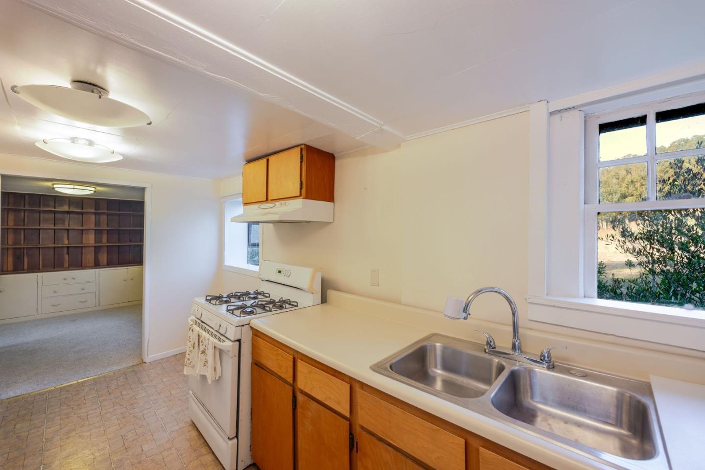 1009 Miramontes Street Half Moon Bay, CA 94019 - Photo 60 of 69 a kitchen that has a sink and a stove top oven