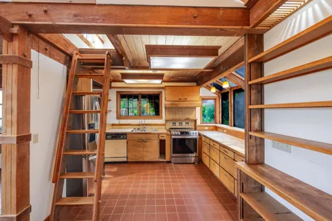 a bathroom with a granite countertop sink toilet and a mirror
