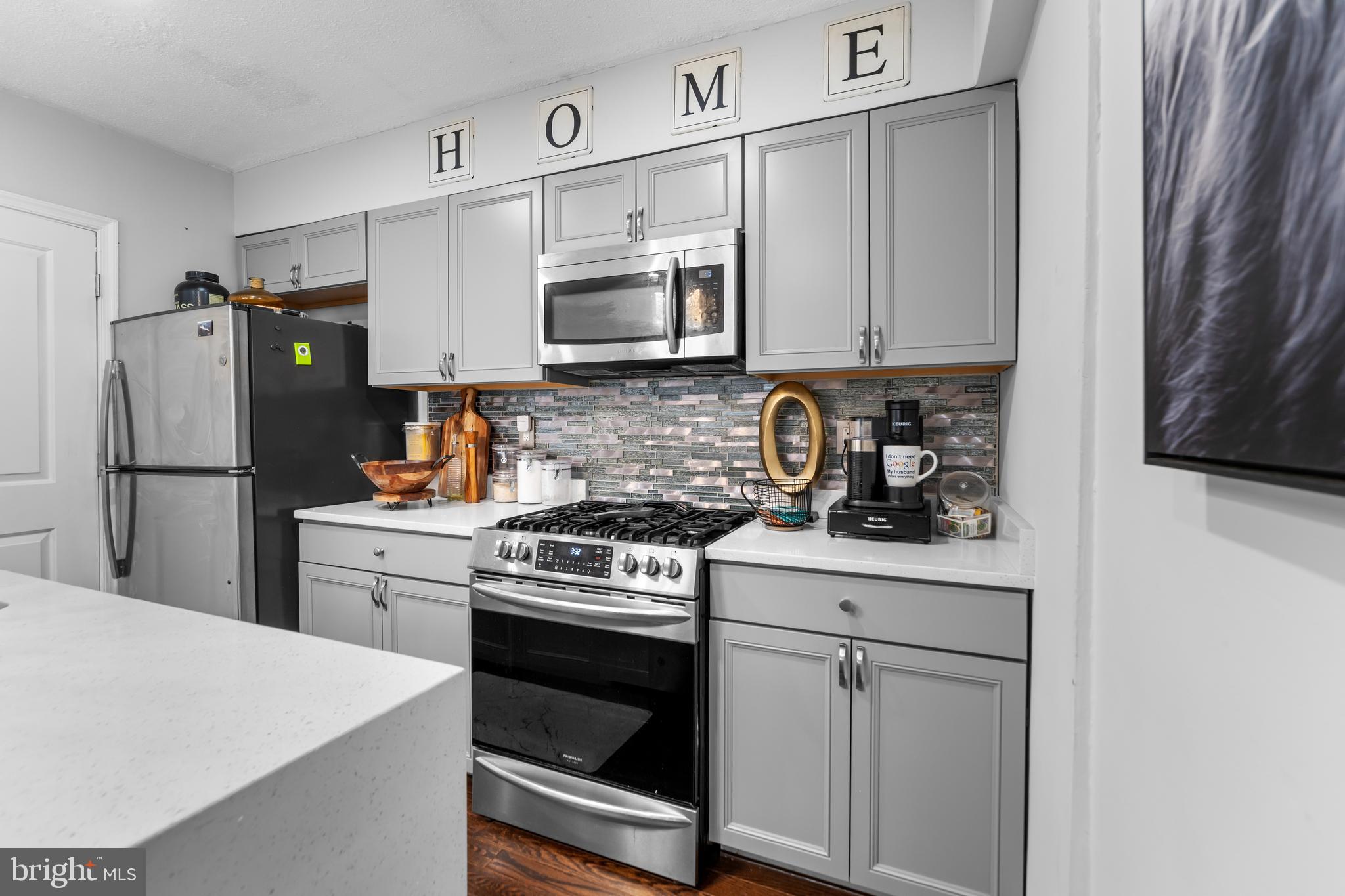 1420 V Street Southeast Washington, DC 20020 - Photo 11 of 29 a kitchen with stainless steel appliances white cabinets and white appliances