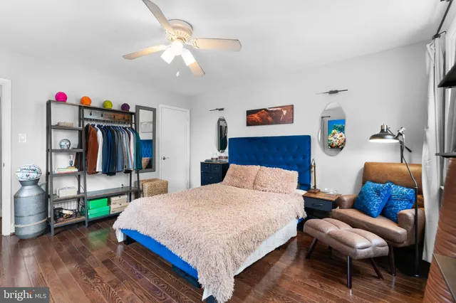 a bedroom with a bed a couch and chandelier