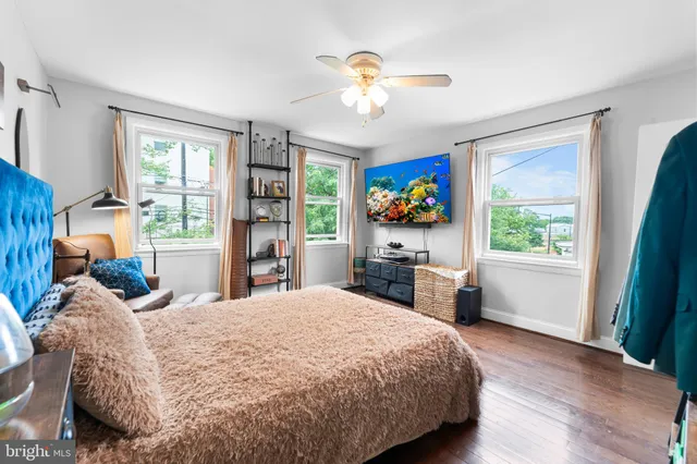 a bed sitting in a spacious bedroom next to a window