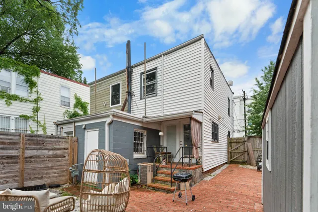 a view of a house with backyard and sitting area