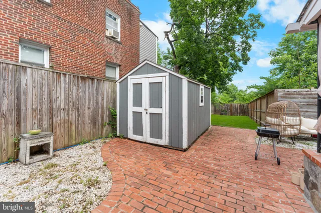 a white house that has a tree in front of it