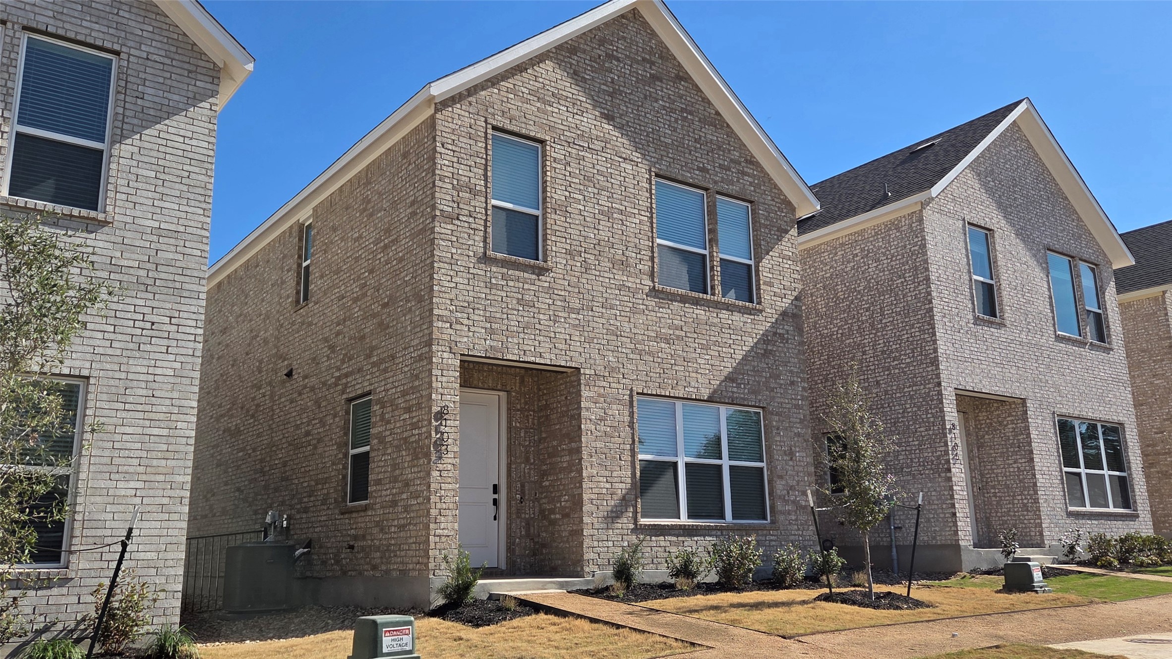 8107 Wilder Road Austin, TX 78736 - Photo 22 of 35 A striking brick facade home offers a modern aesthetic and inviting entryway.