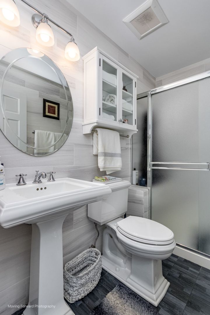 2219 Barrett Drive Algonquin, IL 60102 - Photo 19 of 55 a bathroom with a sink toilet a mirror and shower