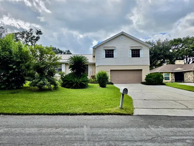 a front view of a house with a garden and a yard
