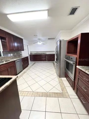 a kitchen with a sink a stove and cabinets