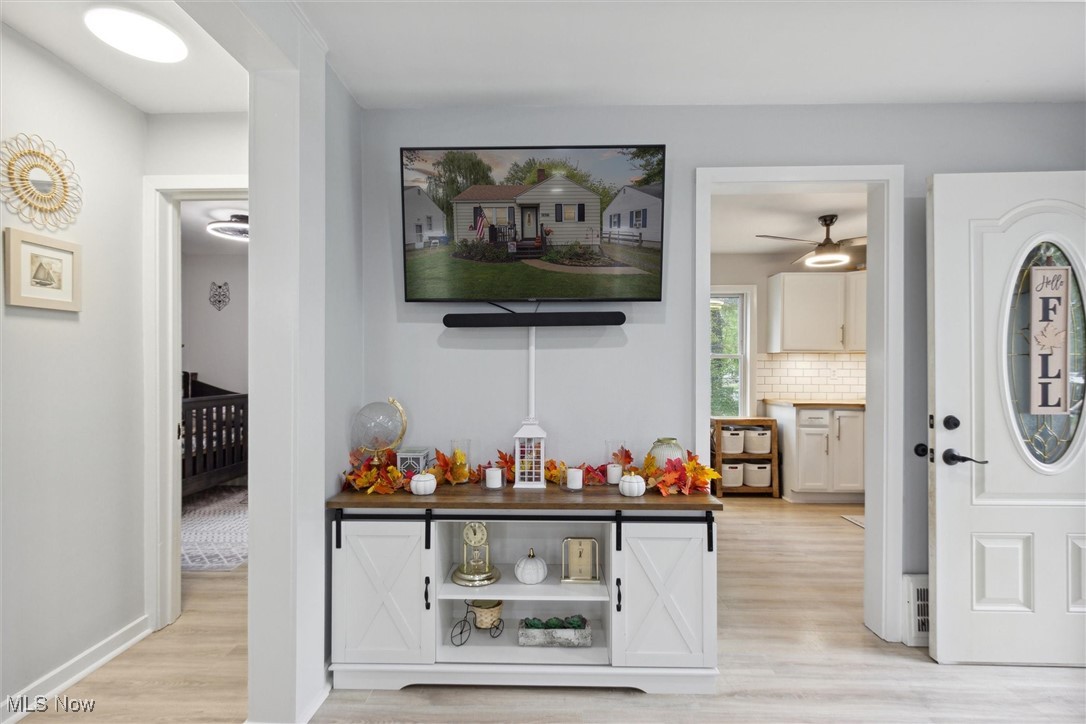 373 Erie Road Vermilion, OH 44089 - Photo 16 of 29 Bar with backsplash and light hardwood / wood-style floors