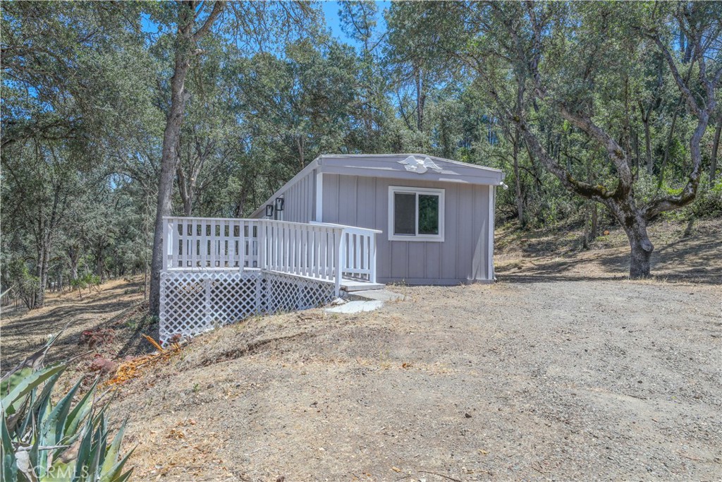 15905 Kugelman Street Lower Lake, CA 95457 - Photo 3 of 75 a view of a house with a backyard and wooden fence