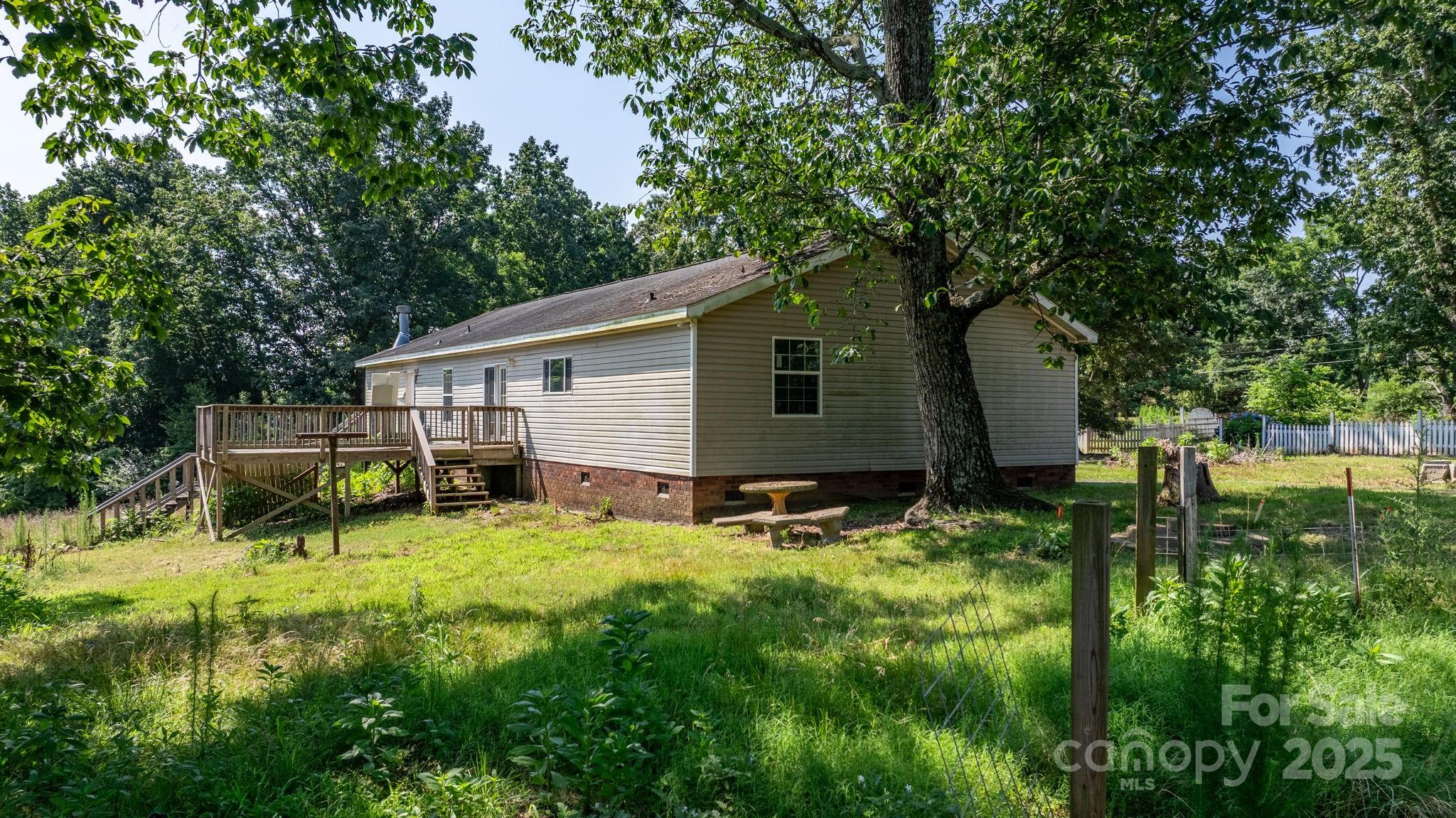 6314 Providence Church Road Vale, NC 28168 - Photo 13 of 39 a backyard of a house with table and chairs