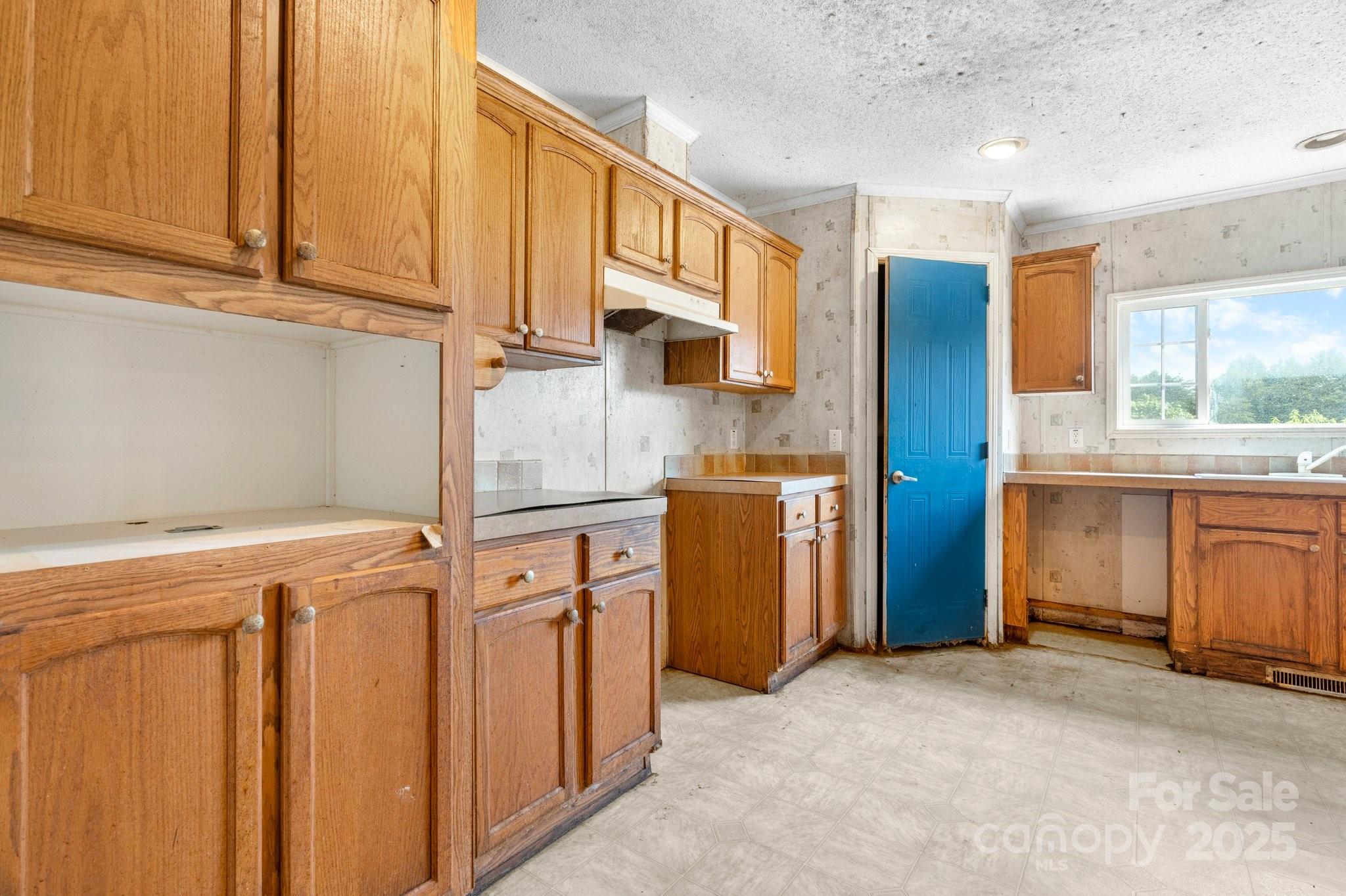 6314 Providence Church Road Vale, NC 28168 - Photo 20 of 39 a kitchen with a refrigerator a sink and cabinets