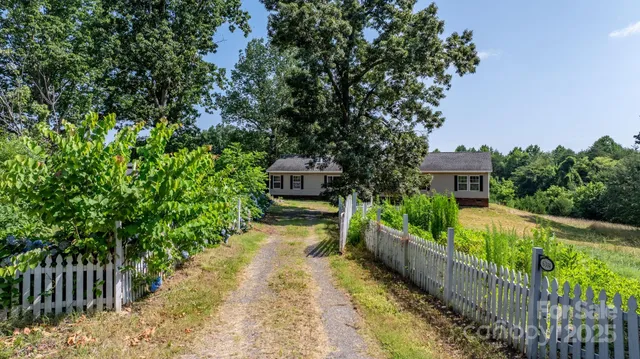 a view of a house with wooden fence