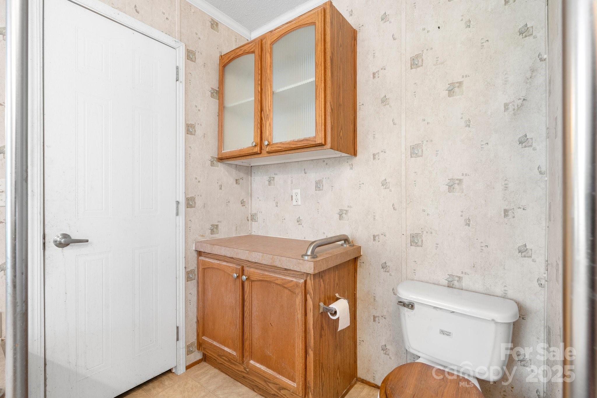 6314 Providence Church Road Vale, NC 28168 - Photo 25 of 39 a bathroom with a toilet a sink and a window