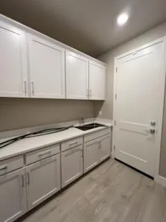 a kitchen with white cabinets and white appliances