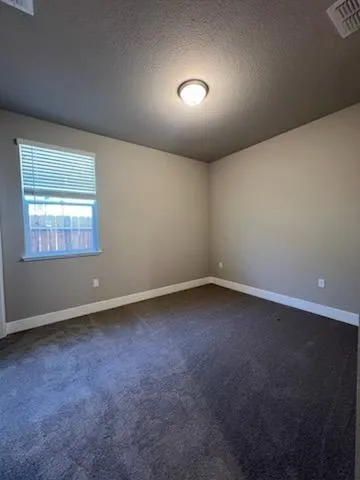 an empty room with a empty space and windows