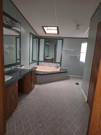 a large bathroom with a sink and mirror