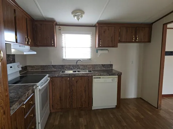 a kitchen with a stove a sink and a refrigerator