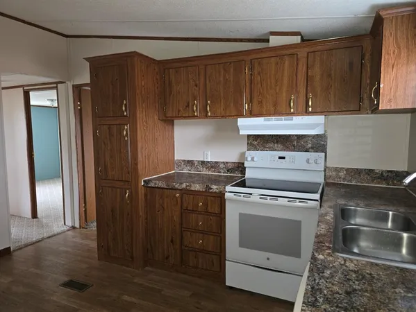 a kitchen with a stove and a refrigerator