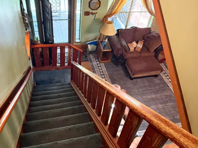a view of staircase with wooden floor and chair