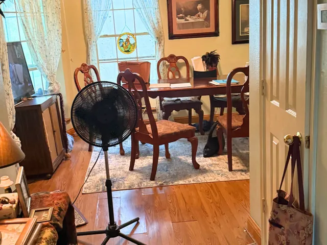a view of a dining room with furniture and chandelier