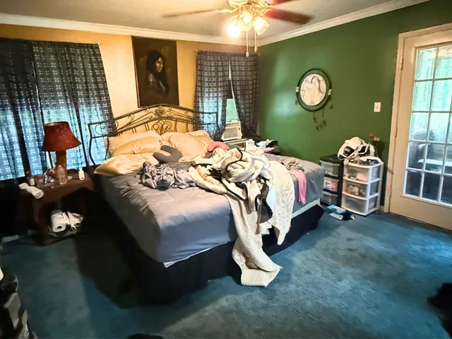 a bedroom with a bed and a wall painting