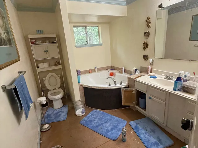 a room with furniture a flat screen tv and a toilet