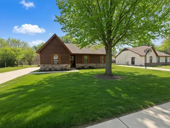 a house view with a garden and trees