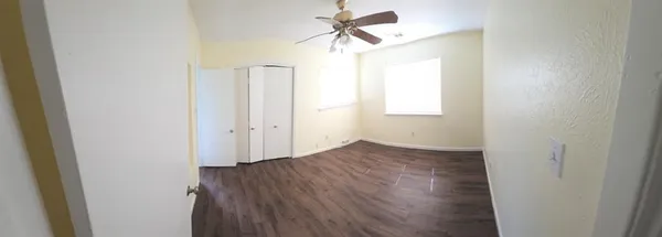 a view of a room with wooden floor and closet