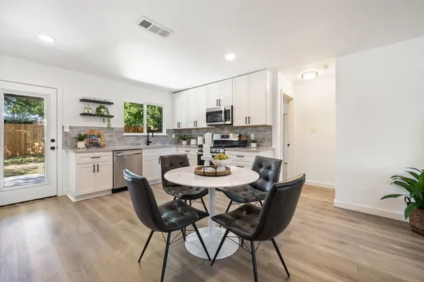 a view of a dining room with furniture and wooden floor