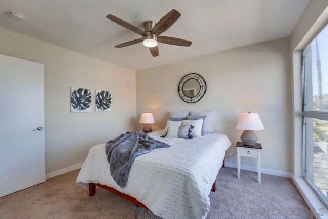 a bedroom with bed and a window