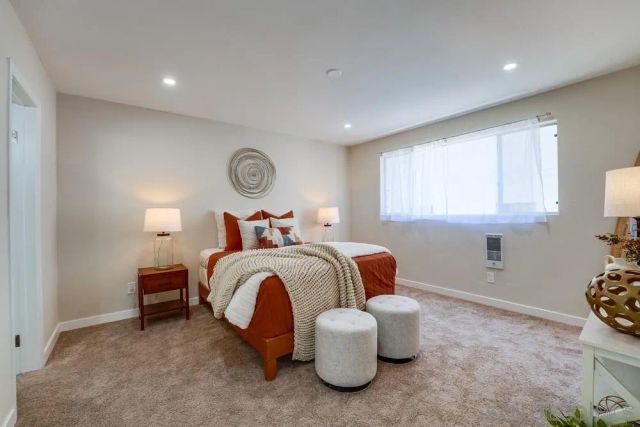 a bedroom with bed and a window